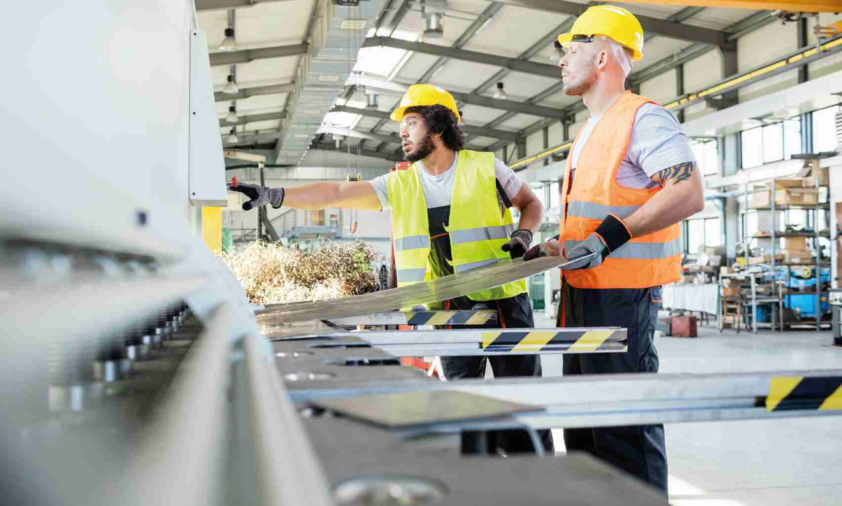 People working on machine inside a manufacturing factory