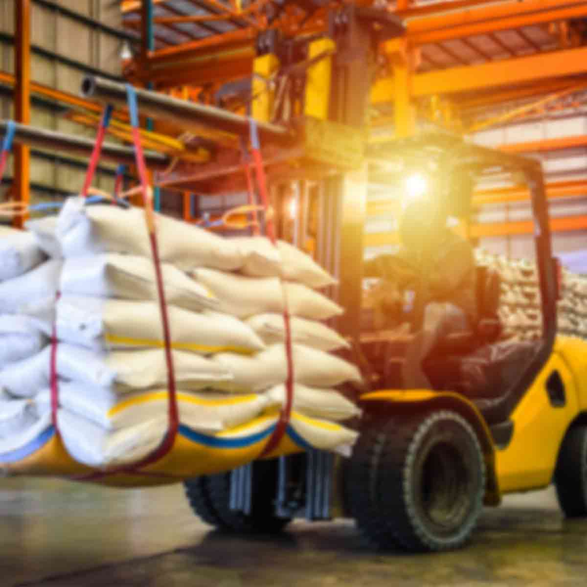 Forklift driving around Warehouse carrying product