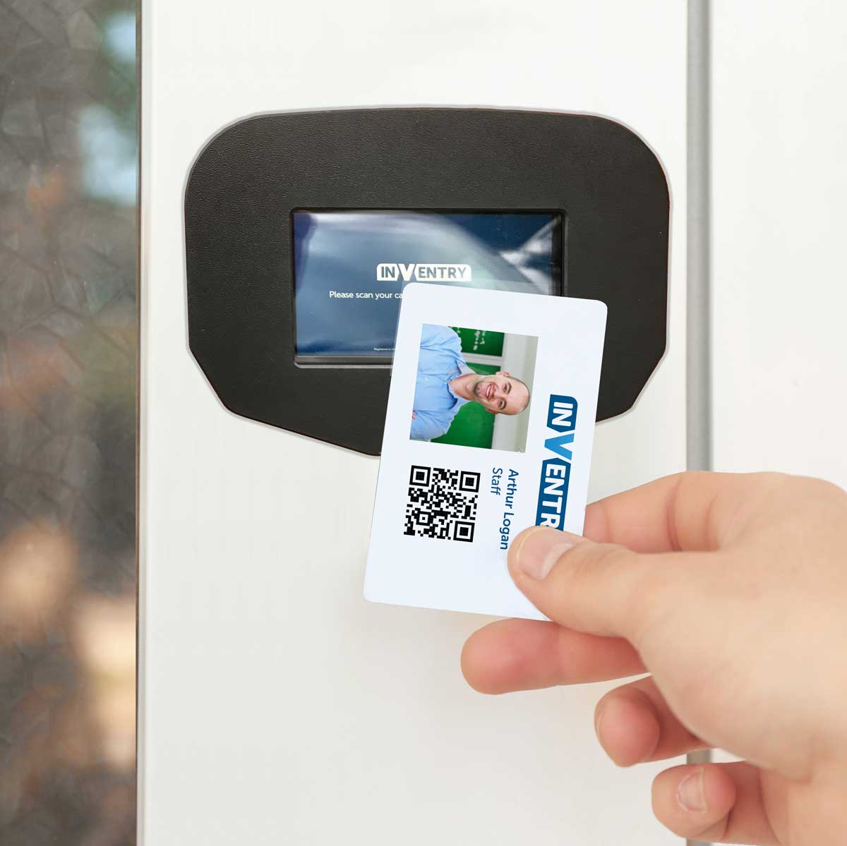 Person scanning an ID card on an InVentry Outdoor Quickscan