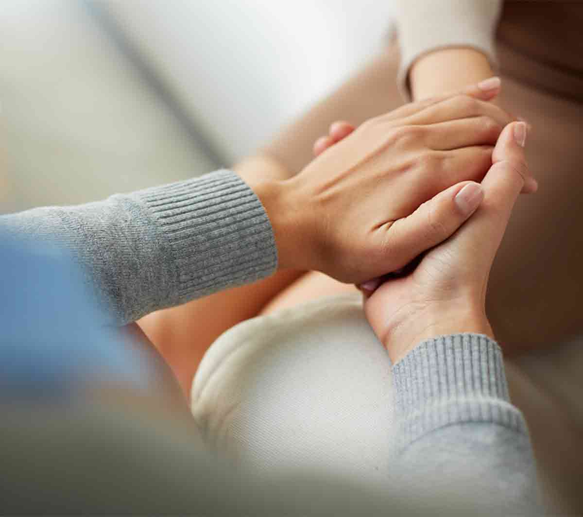 Care Giver Holding Care Receiver's Hand