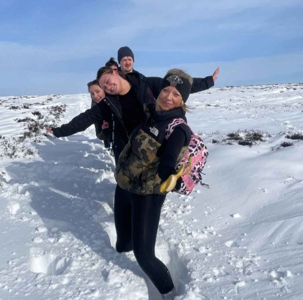 InVentry employees walking through the snow, smiling at the camera