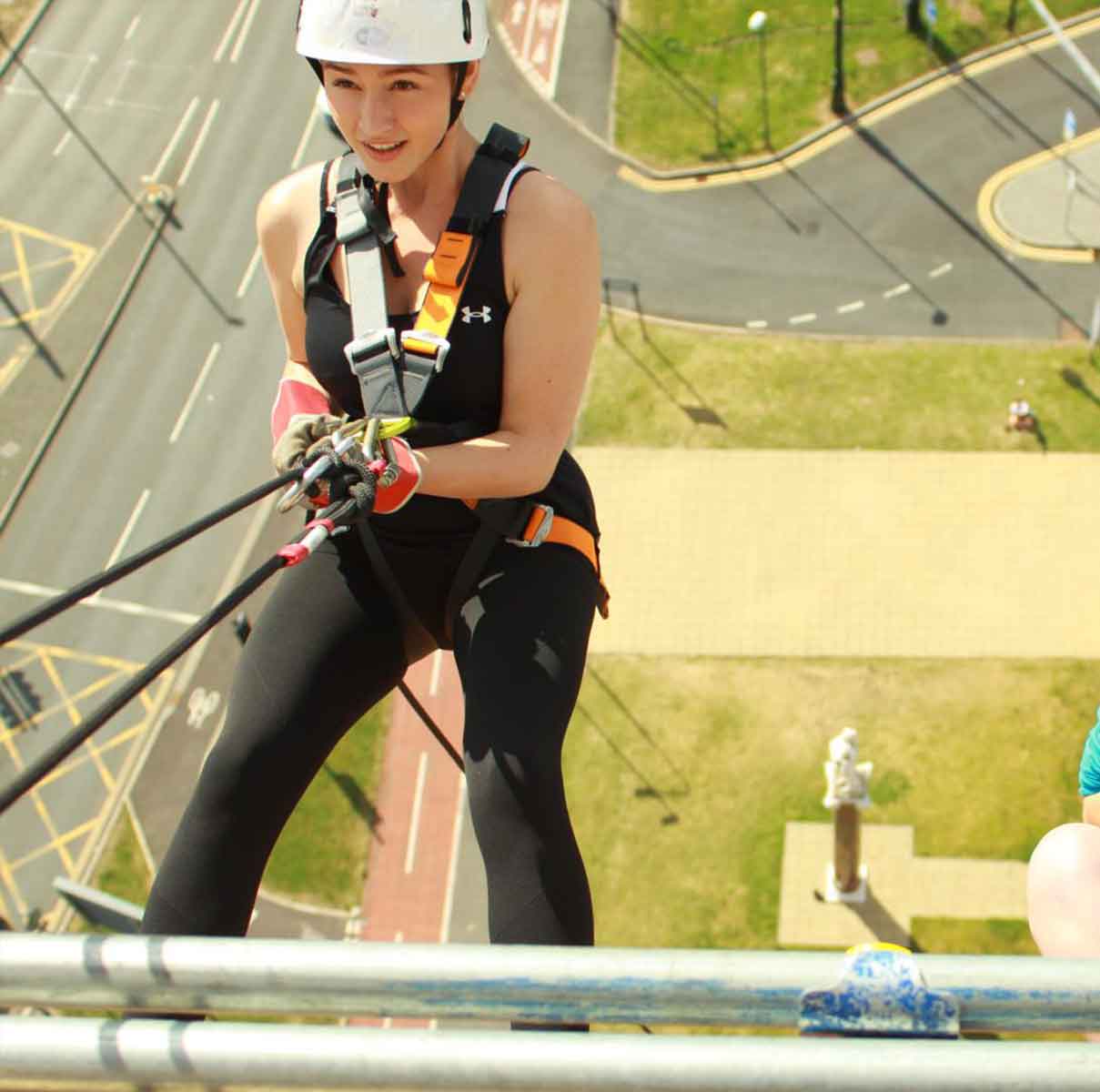 InVentry employee abseiling down building looking up