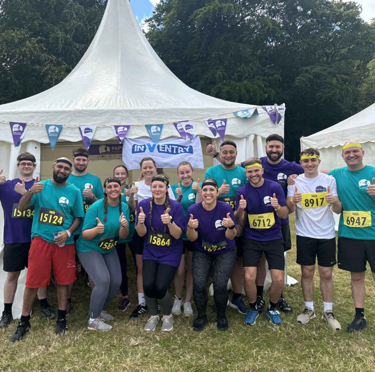 InVenty employees outside an InVentry branded tent before completing Total Warrior